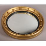 A Regency style gilt convex wall mirror the frame applied with moulded spheres and black reeded