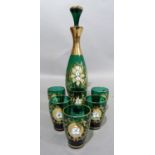 A green and gilt glass liquor set comprising of a decanter and six small glasses