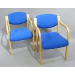 A pair of beech framed reception chairs upholstered in bright blue fabric