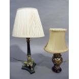 A Regency style metal column table lamp with acanthus wrapped base and three lion paw feet on the