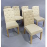 A set of six reproduction dining chairs with buttoned upholstered arched backs and stuffed over