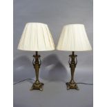 A pair of metal slender baluster table lamps with pleated cream shades