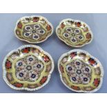 A set of four Royal Crown Derby pattern 1128 shaped circular pin trays, 11.5cm wide