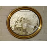 An Edwardian lacquered pressed glass oval mirror with bevelled plate, 57cm wide