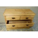 A late 19th/early 20th century pine chest of two short and two long graduated drawers beneath the