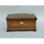 A William IV rosewood veneered sarcophagus shaped tea caddy with bead and reel borders throughout,