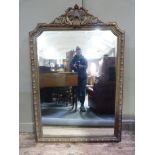A gilt framed wall mirror of C19th design having an elaborate foliate pierced cresting, the