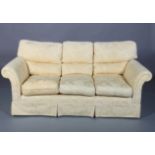 A yellow cotton upholstered three seater sofa