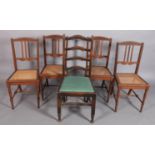 A set of four oak dining chairs with carved top rails, three vertical slats, caned seats, turned