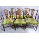 A set of six mahogany dining chairs in Hepplewhite style, with camel shaped backs, pierced waisted