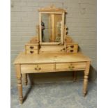 A late Victorian dressing table, the mirror with carved architectural cornice supported on a pair of