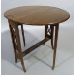 A 1920's mahogany Sutherland table having twin oval drop leaves, refectory supports with pierced