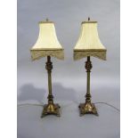 Pair of reproduction brass columnar table lamps on spreading circular bases with square plinths