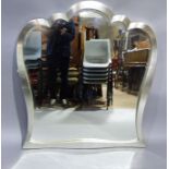 A large modern wall mirror with triple arch profile, silvered frame with bevelled glass, 107cm W x