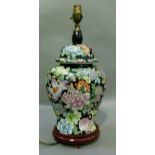 A reproduction Chinese style vase of famille rose on a black ground, 48cm high to the fitting