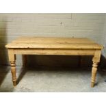 A pine breakfast table, the rounded rectangular top above a frieze fitted single drawer and turned