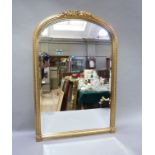 A Victorian style gilt wall mirror, arched profile with foliate cresting and beaded frame, the