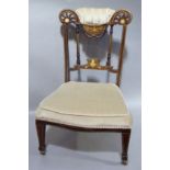 A late Victorian rosewood and ivorine inlaid nursing chair having a partially upholstered top rail