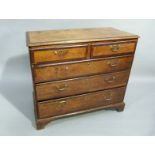 A George III oak chest of drawers crossbanded throughout with mahogany, fitted with two short and