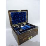 A C19th coromandel dressing and jewel box, having a brass cartouche, interior inset with a mirror,
