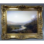 A large gilt framed reproduction colour print of a river valley landscape, 108cm x 135cm including