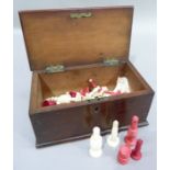 A natural and red stained composite bone chess set and other part sets, contained in a mahogany