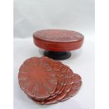A red lacquered hors d'oeuvre set in a pedestal stand with the cover moulded with chrysanthemum;
