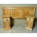A pair of pine bedside chests the tops above single drawer and cupboard on skirted bases, 38cm