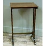 An early 20th century rosewood occasional table on twin turned refectory standards from a nest of