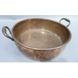 A two handled copper stock pan 49cm over handles