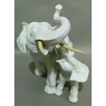 A white pottery figure of an elephant with ivorine tusks, 35cm high