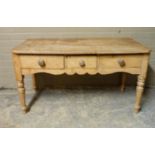 A Victorian pine side table the rectangular top with rounded front corners above one short central