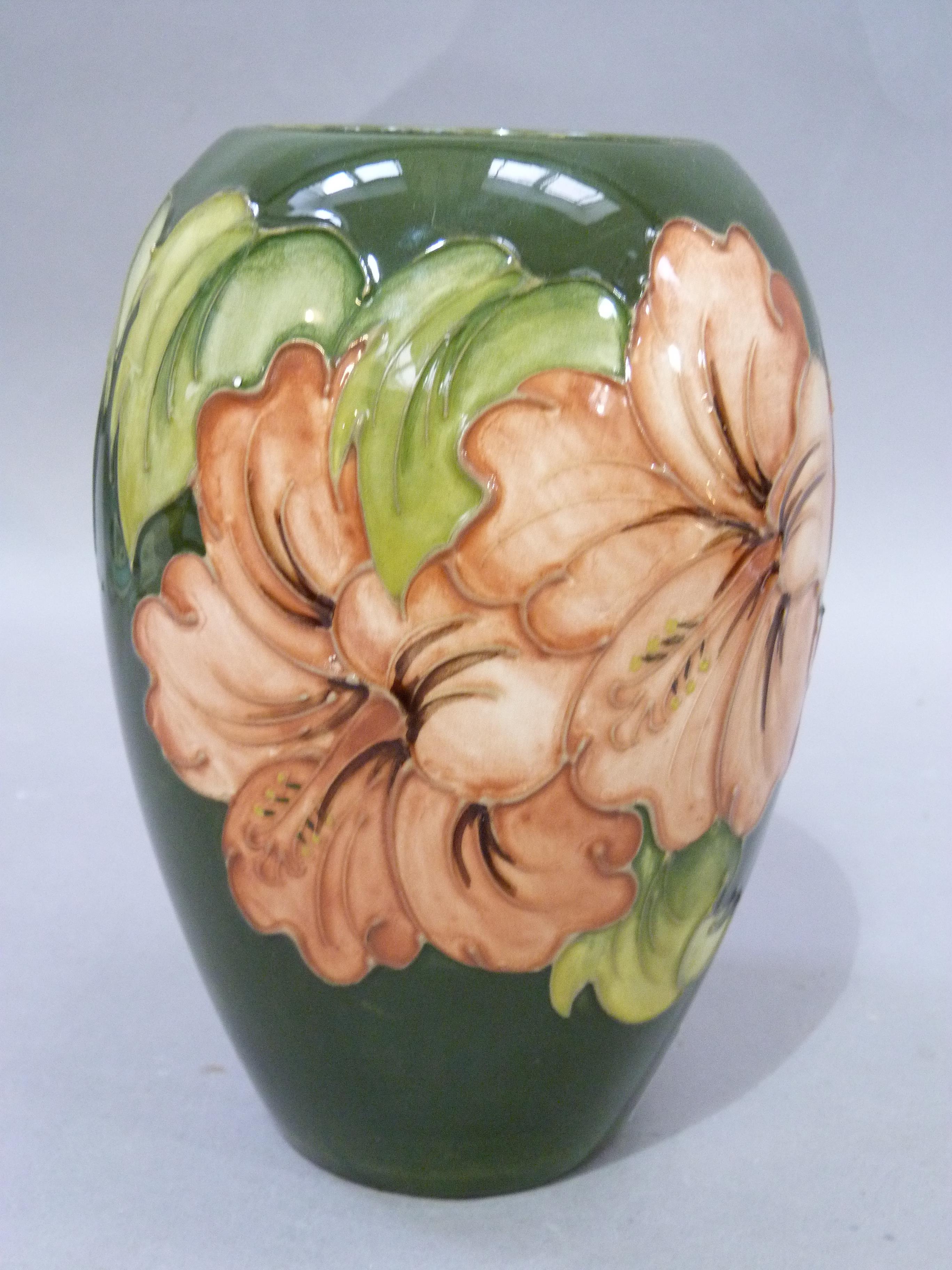 A Moorcroft pottery vase of ovoid shape, tube lined and glazed in coral and green wiith hibiscus, - Image 2 of 3