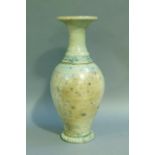 A baluster vase with everted rim, the raku glaze tinted from duck egg blue to turquoise. on circular