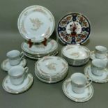 A Crown Ming dinner service with tea cups and saucers, soup plates, dessert and dinner plates