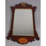 A Vauxhall style fretted frame wall mirror with gilt ho-ho bird finial the base with shaded shell