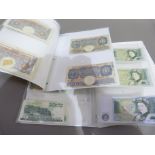 Folder containing four one pound notes, signature K.O. Peppiatt plus folder containing nine