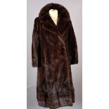 A mink coat with rever collar, double breasted and swing line, the lining embroidered Nancy, size