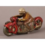 A vintage Schuco-Sport printed tin plate clockwork motorcycle and rider, independent front wheel,