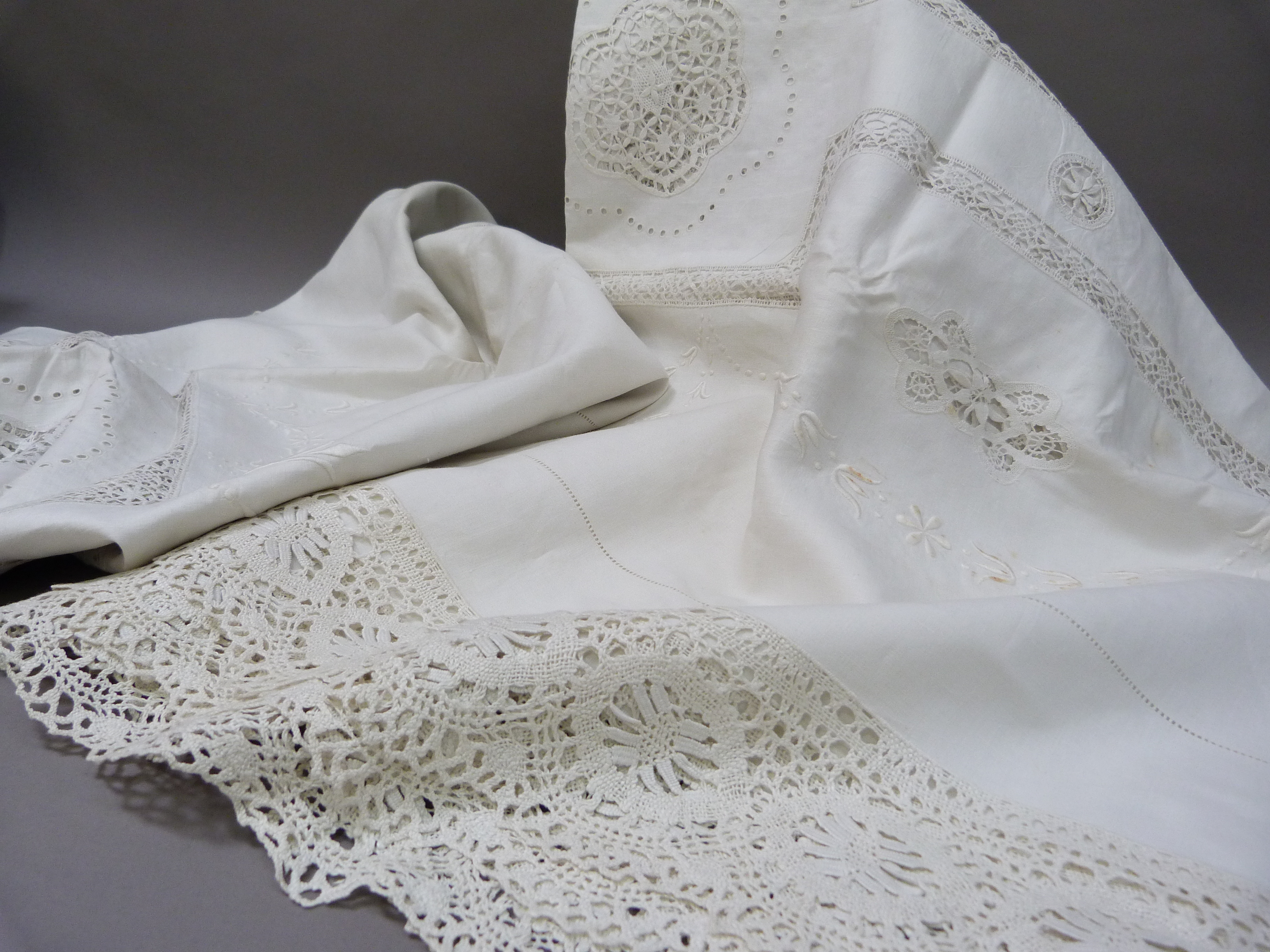 A pair of white embroidered, lace inset and fringed bedspreads, single size, 176cm x 254cm approx