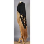 A black and gold embroidered piano shawl with fringe