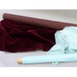 A length of vintage maroon velvet fabric and a length of sheer turquoise fabric