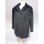 A Persian lamb jacket with three quarter length sleeves , side splits and slit pockets, approx