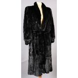 A sable coat with stand up collar, edge to edge fastening, slit pockets, the sleeves gathered into a