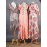 A floral printed full length zipped morning coat together with a pink full length gown with short