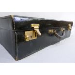 A ladies black leather suitcase initialled BH, the interior lined in moiré silk 53cm x 35cm x 15.2cm
