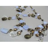 A festoon necklace of faceted smoky quartz and stained fresh water cultured pearls hung with rock