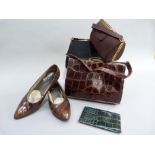 A chestnut brown crocodile skin handbag with gilt metal frame, a black Waldy bag and a similar bag