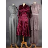 A maroon satin two-piece outfit, jacket with tie belt and wrap-around skirt, size 2, together with a