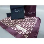 A Christian Dior scarf, claret and ivory, in packaging, together with two silk scarves by Pierre